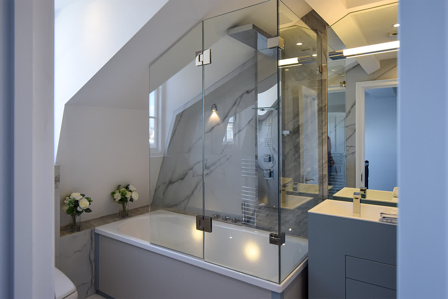 bespoke corner bath screen under eaves with a hinged panel