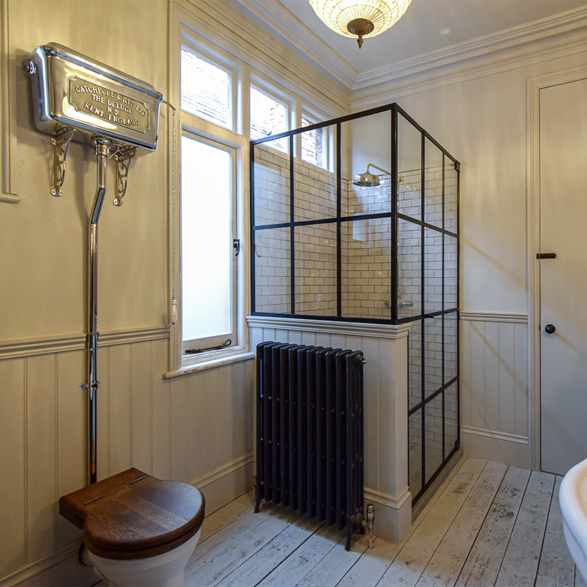black grid shower enclosure in a bathroom corner