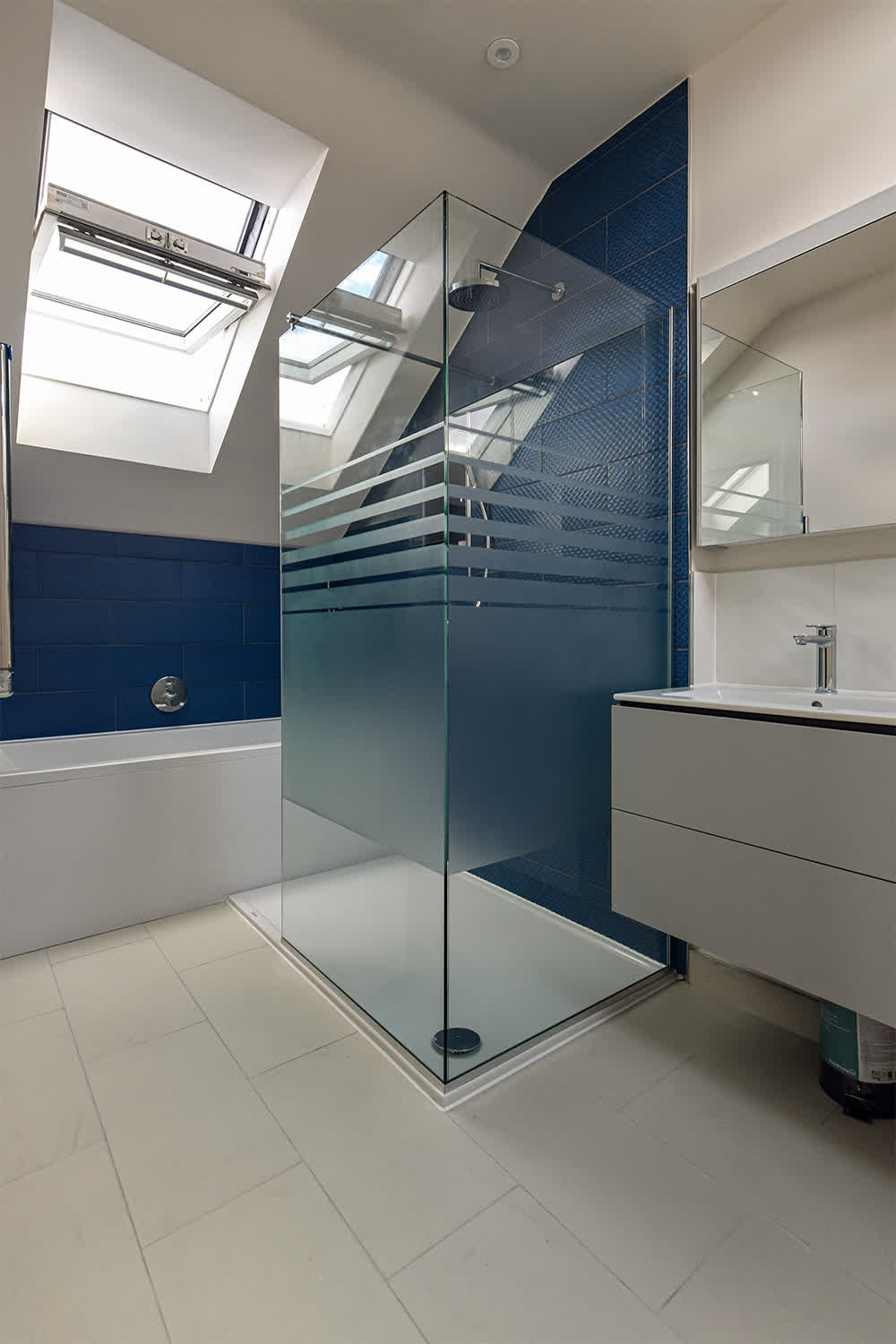 bespoke L-shape shower screen with custom sandblasted design