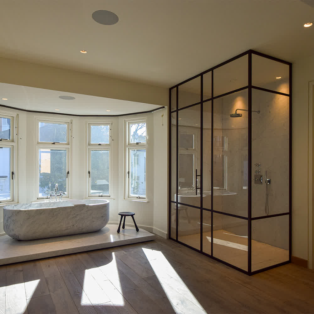tall custom shower enclosure with bronze frame and door