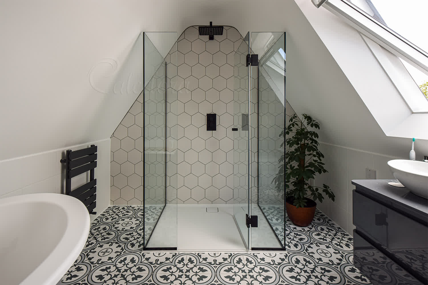 Frameless 3-sided shower cubicle with door opened inward showing minimalistic seals on beige tiled bathroom