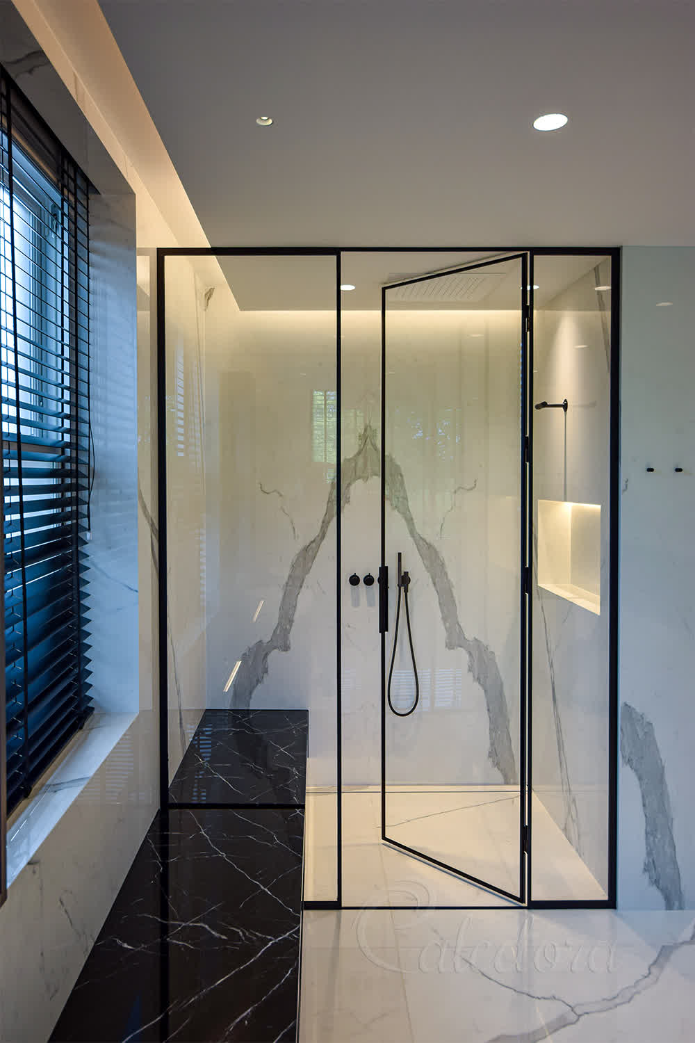 Black framed shower enclosure with ultra clear glass in marble bathroom
