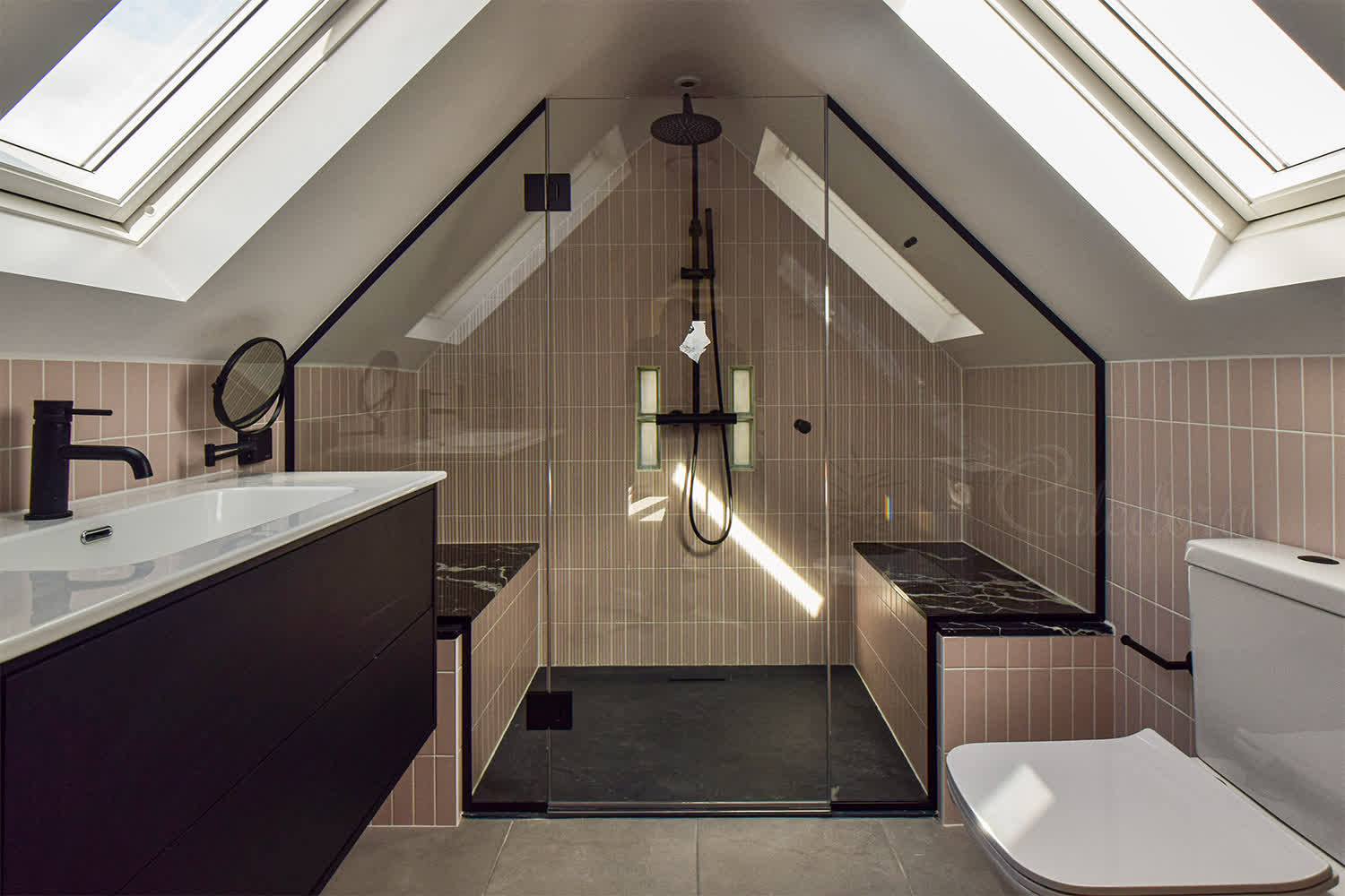 Black shower enclosure under eaves with frameless door and custom-shaped fixed panels
