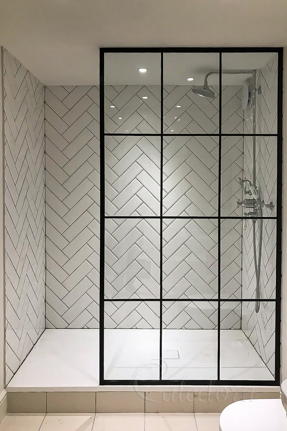 Black square shower screen with grid pattern in modern bathroom with herringbone tiles
