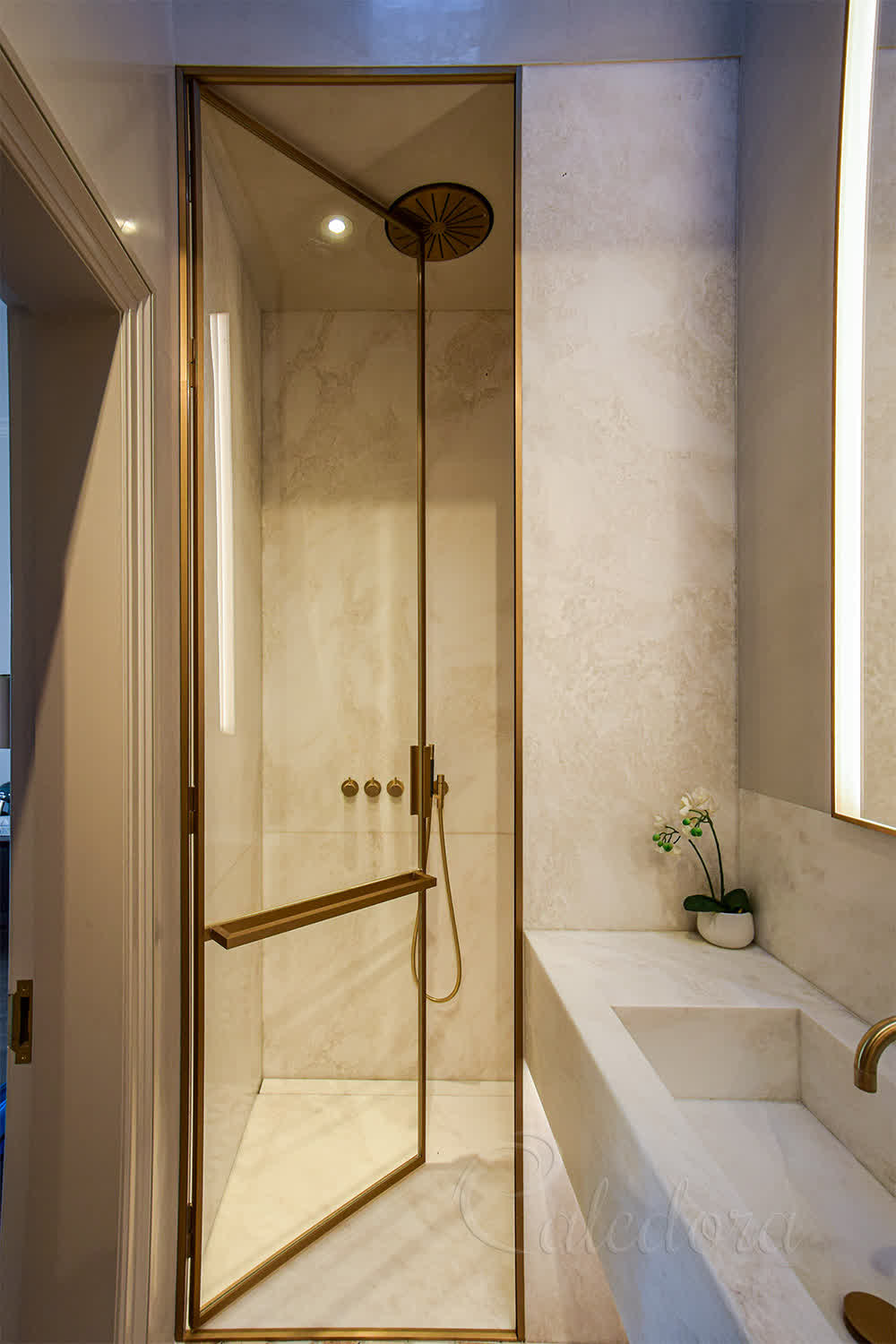 Full-height brass door frame with recessed seals and no exposed fittings