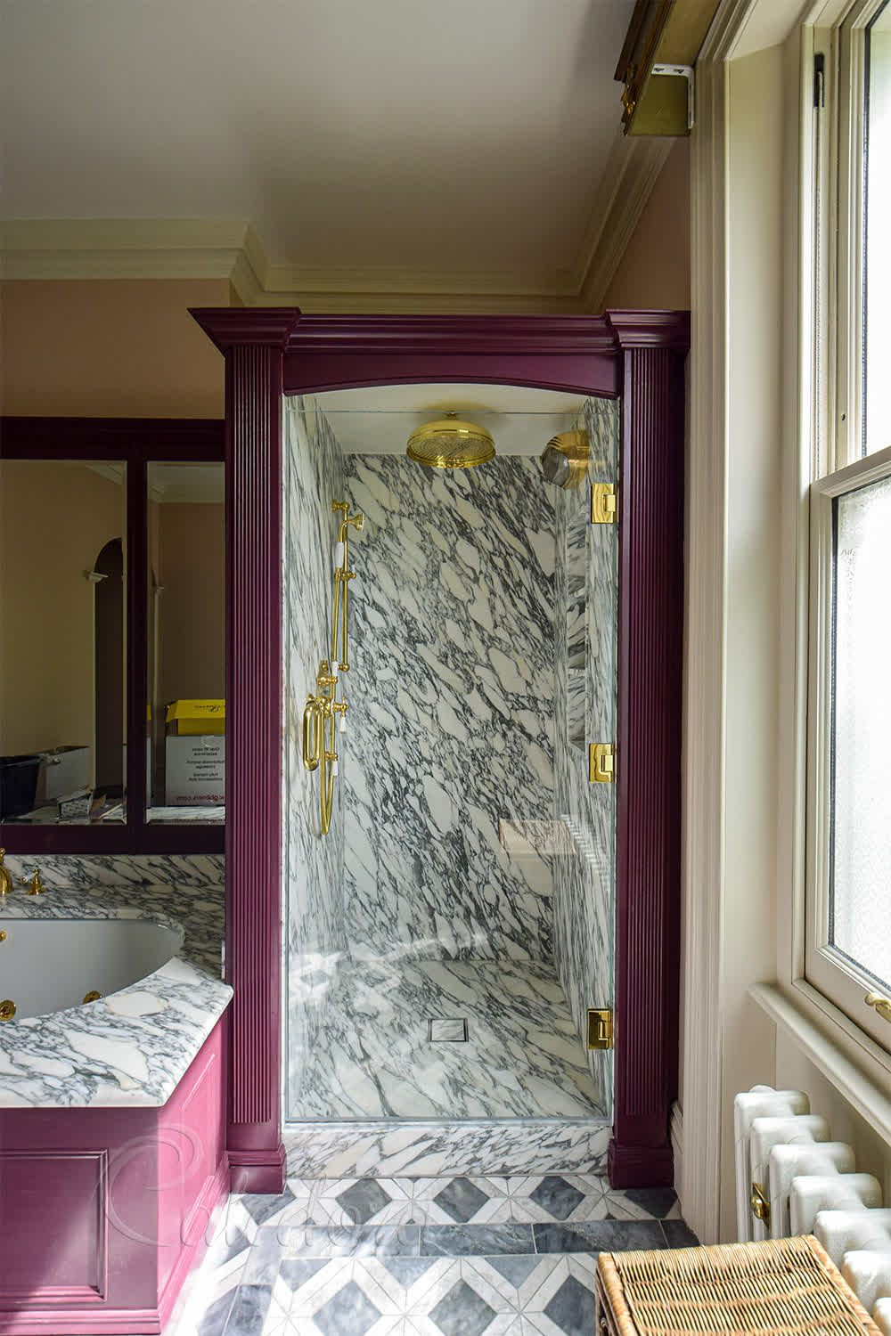Frameless brass shower door with Ultra Clear glass and polished brass hinges