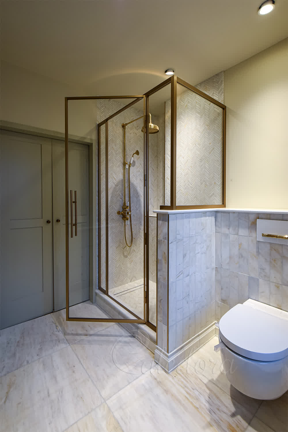 Brass shower enclosure with aged brass anodising in luxury Central London bathroom