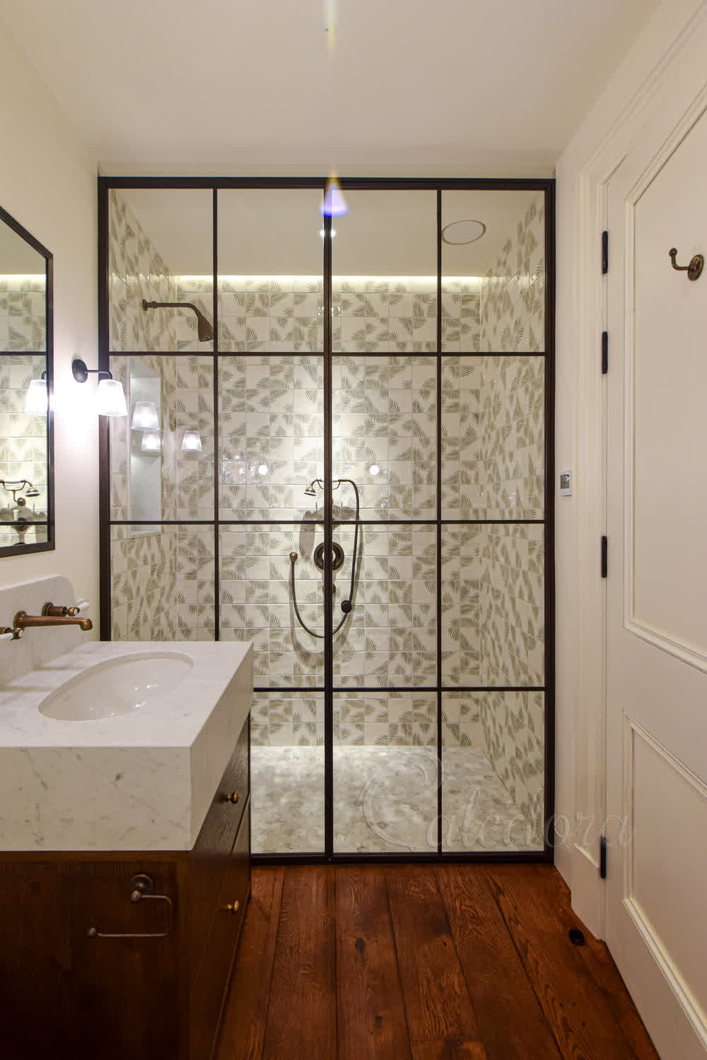 Full-height bronze shower enclosure with inward-opening door and ultra clear glass