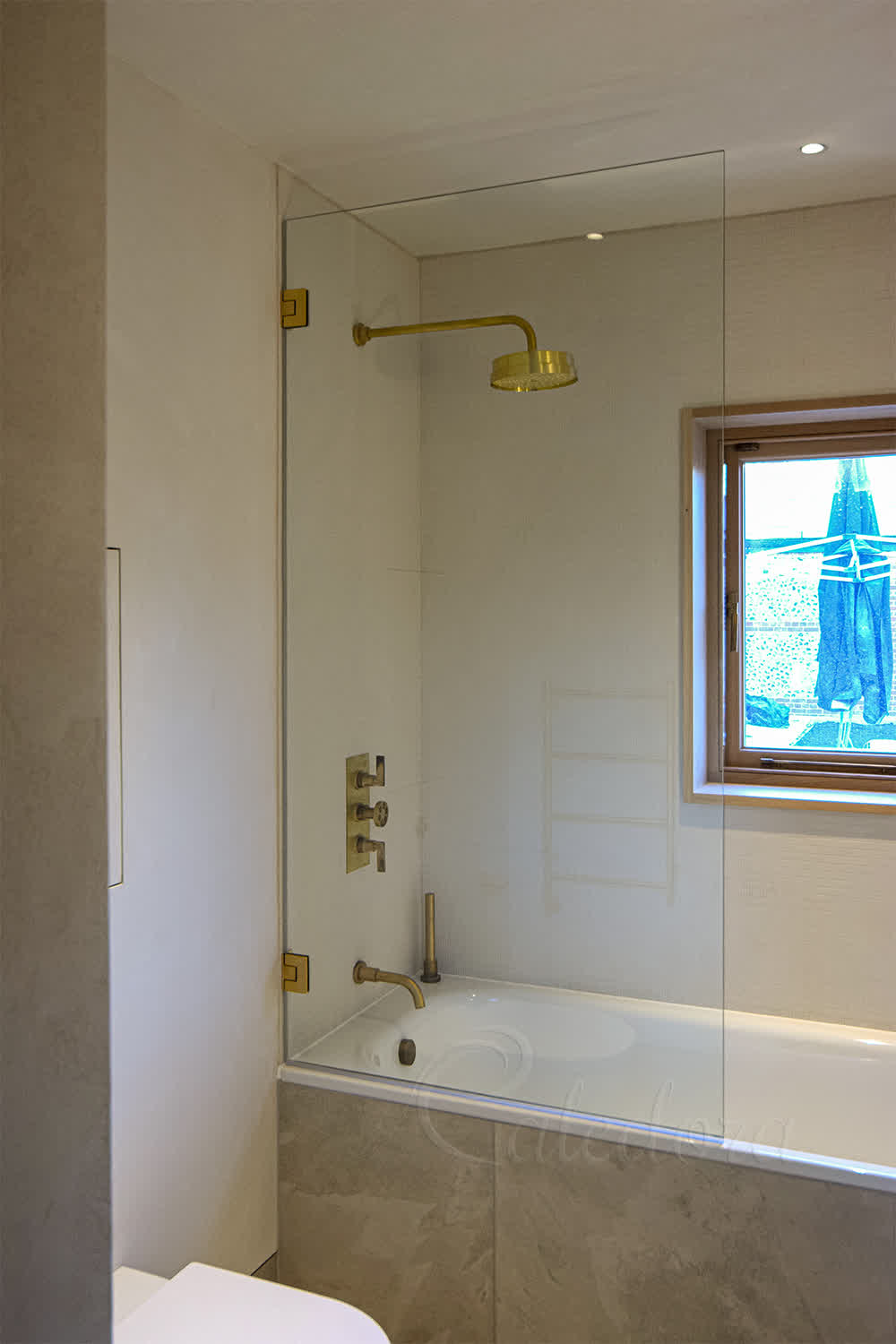 first bathroom brushed brass bath screen in closed position