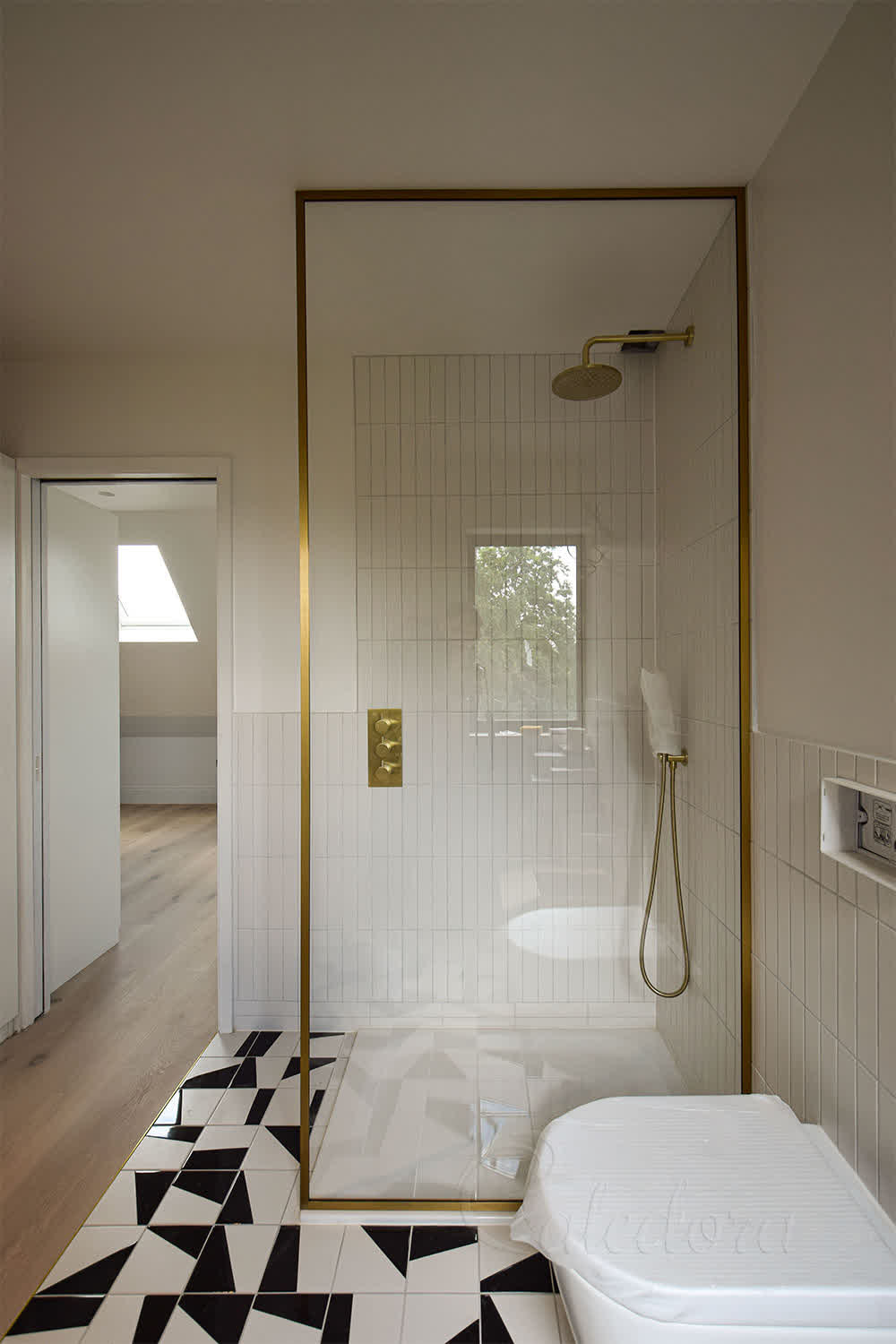 Full-height brushed brass shower screen with ultra clear glass in London bathroom