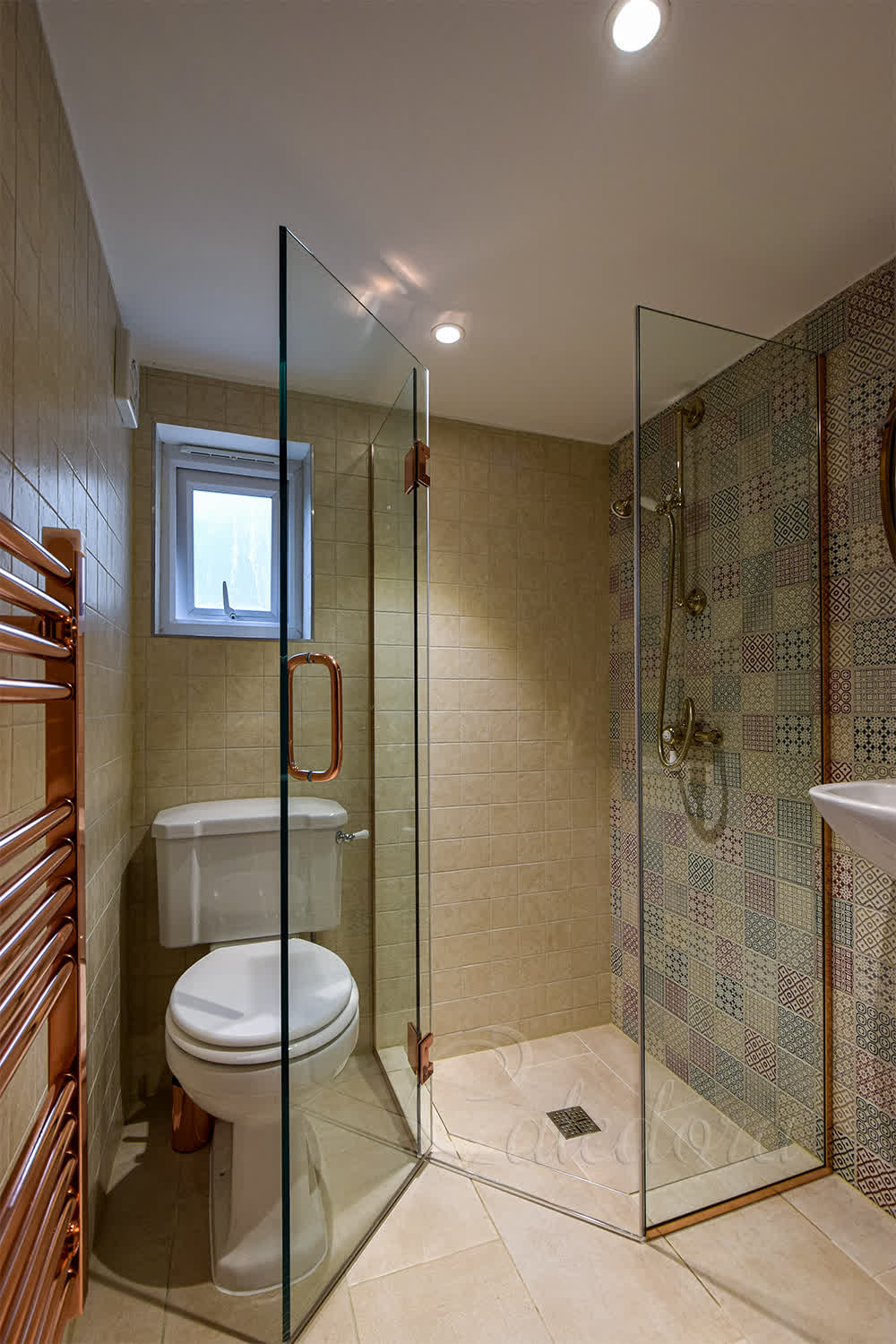 Diamond shower enclosure with clear glass and polished copper hinges in small bathroom