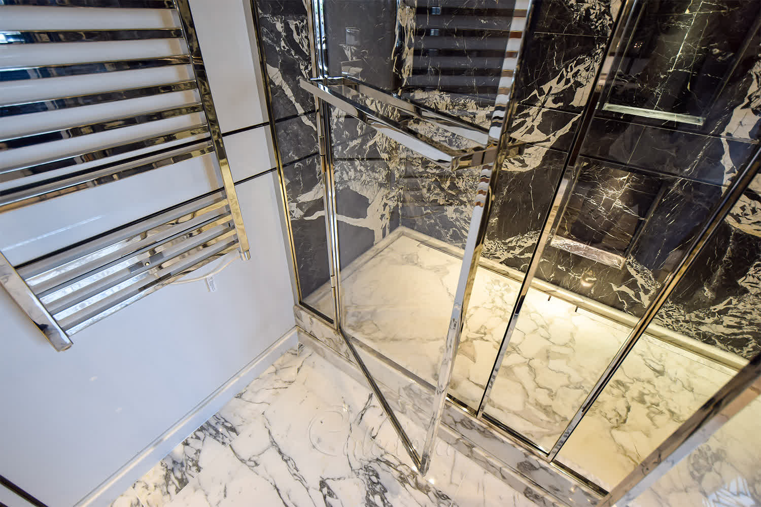 Close-up of seamless joints on luxury double shower enclosure with nickel finish