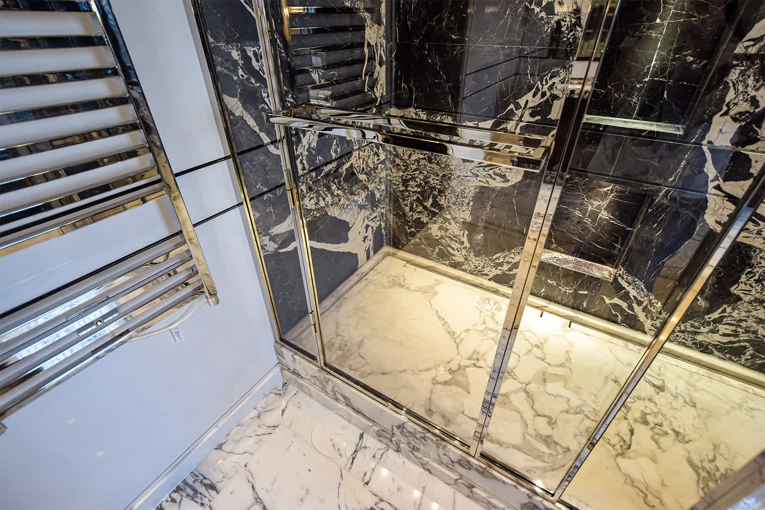 Interior view of double shower with two separate shower areas and frameless design