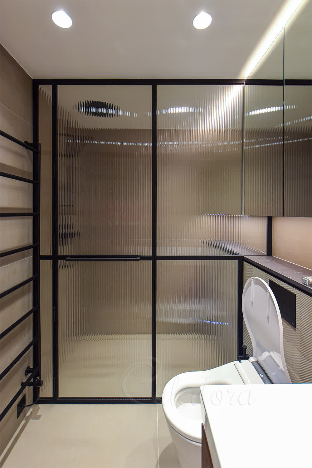 Fluted glass shower enclosure with matching layout in second bathroom