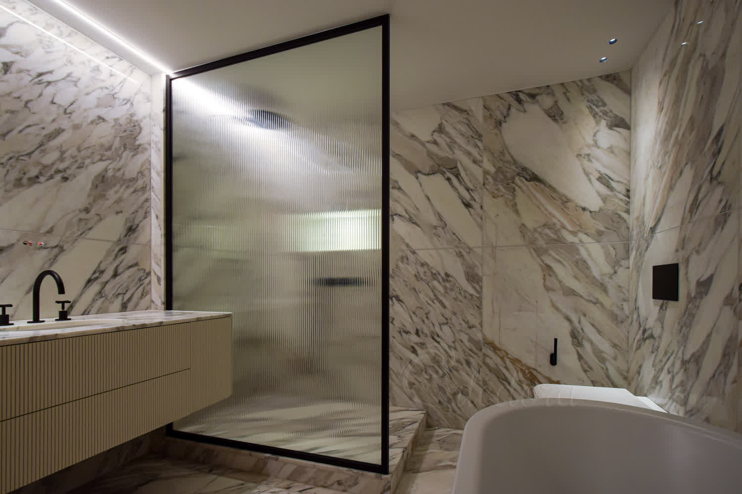 Fluted glass walk-in shower screen with black perimeter frame