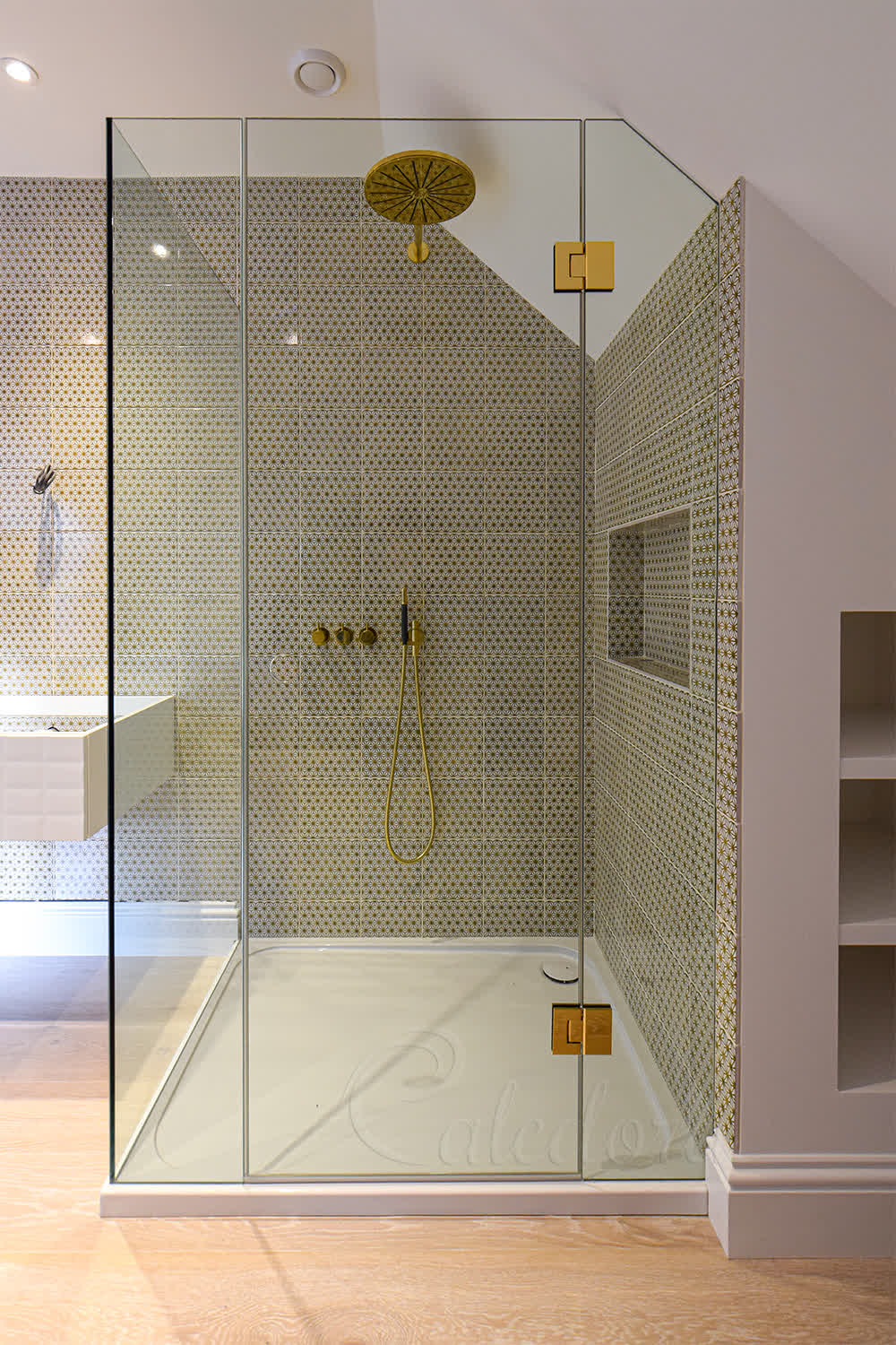 Glass panels shaped to fit loft ceiling angles in bespoke shower design
