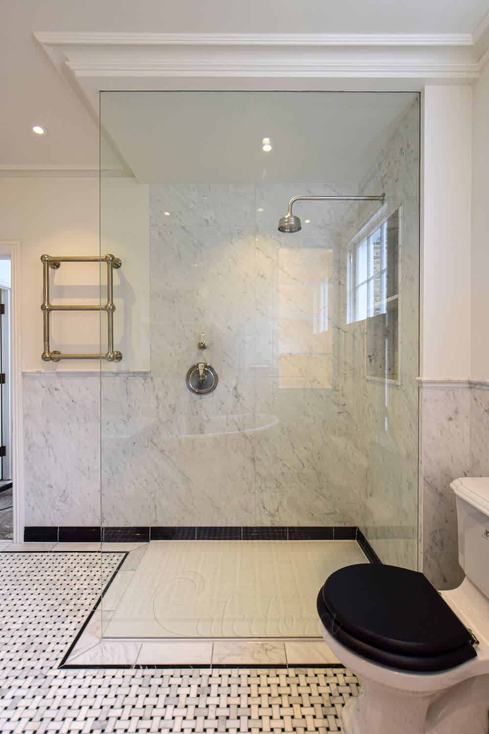Walk-in full height glass screen sealed at the top and bottom with clear mastic