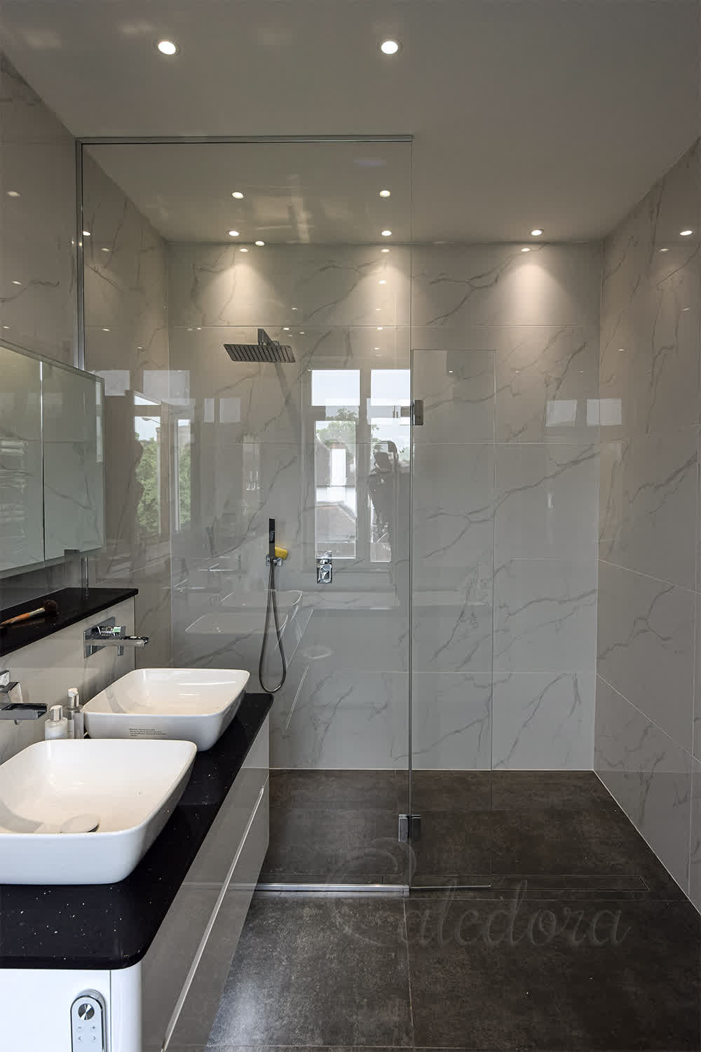 Full height shower screen with flipper panel in London bathroom featuring ultra clear glass and chrome hardware