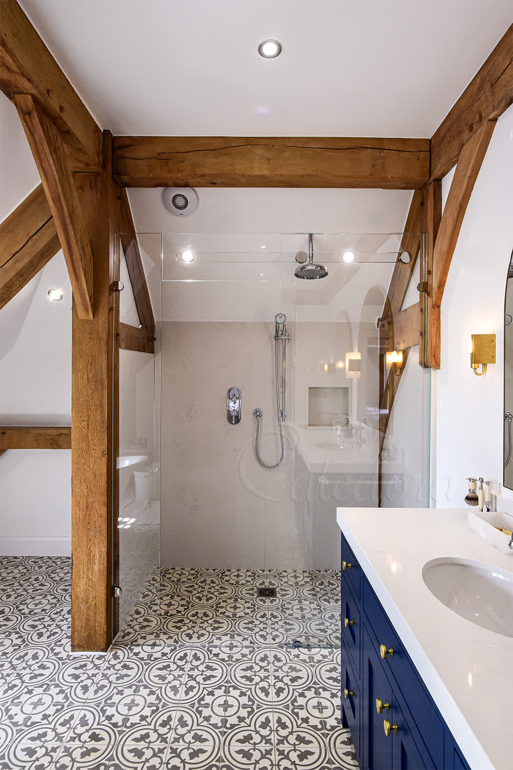 Frameless sliding shower screen with trackless system and ultra clear glass in modern bathroom with natural stone walls