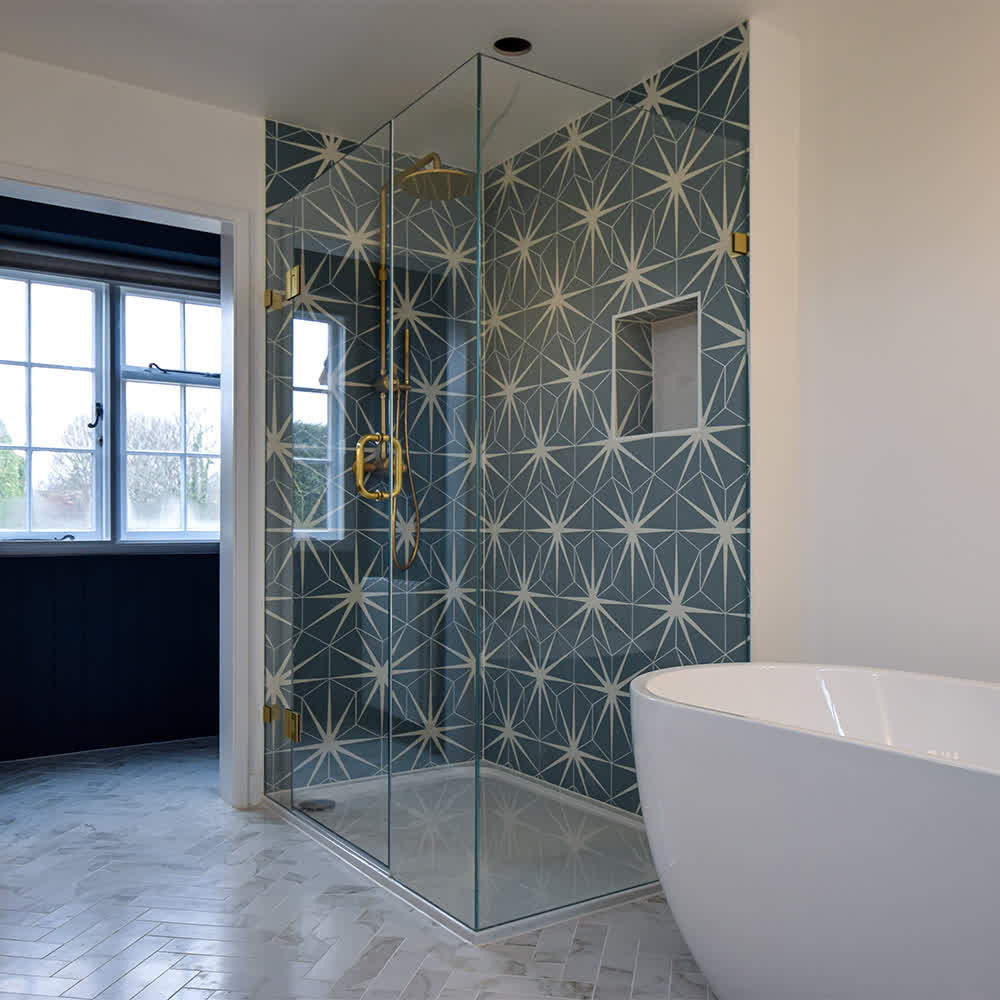 frameless enclosure with brass fixtures