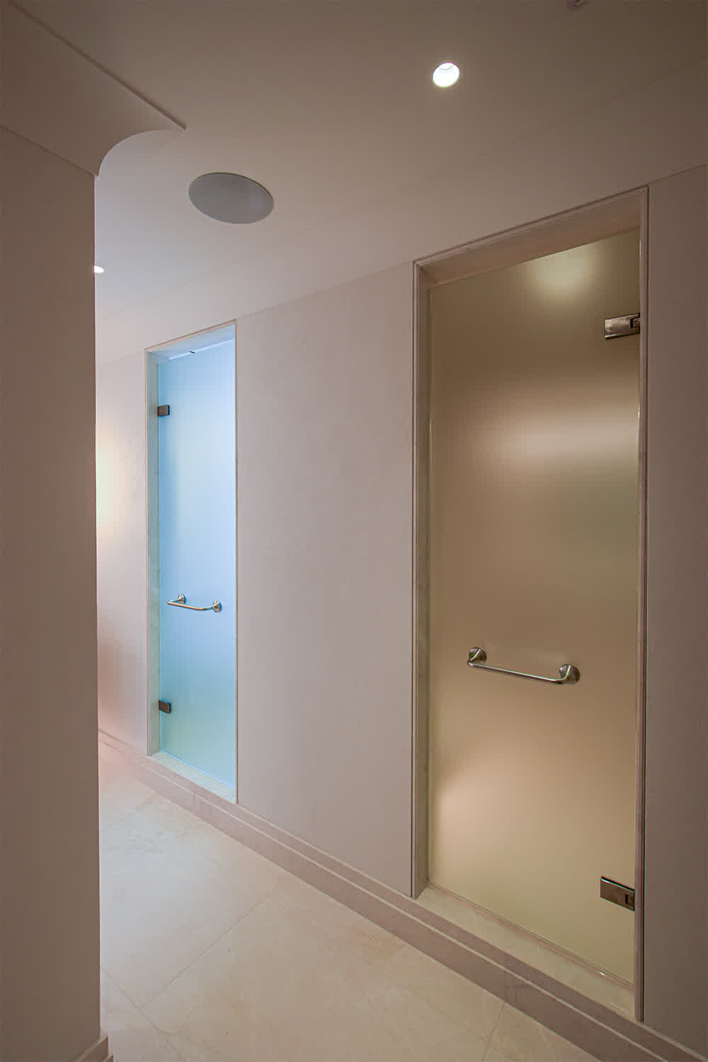 two frameless shower doors with frosted glass