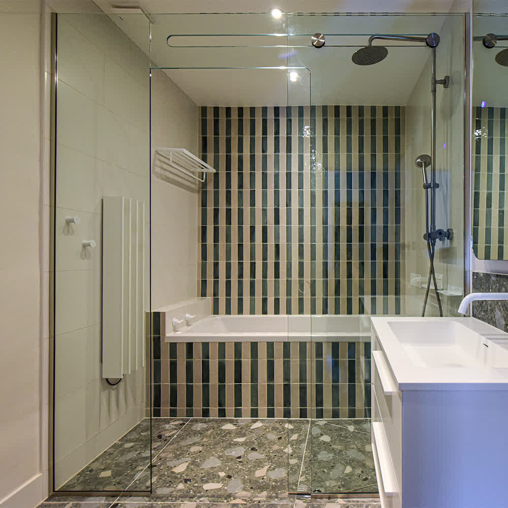 sliding shower enclosure with U-channels on the wall