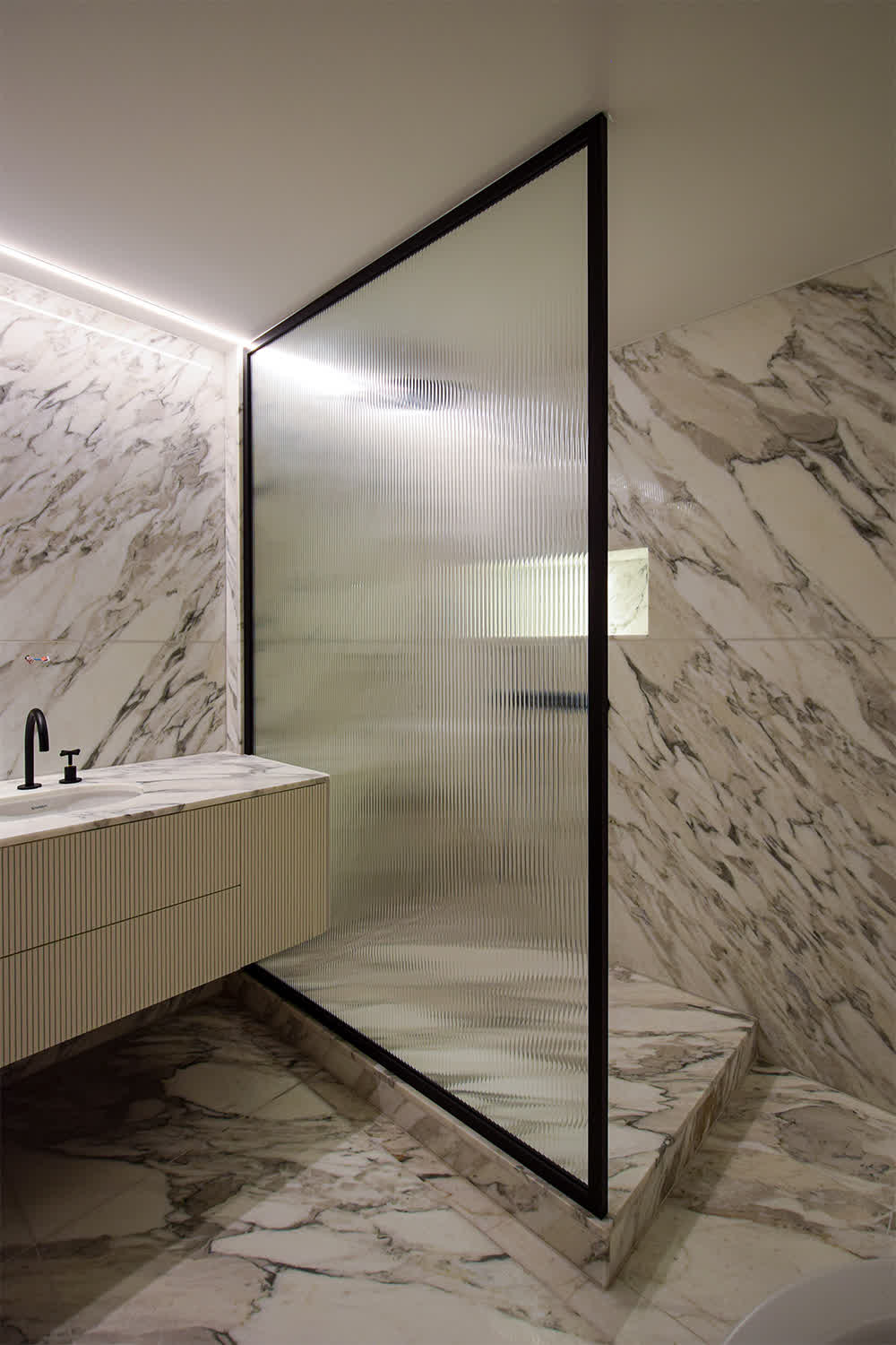 black frame shower screen with a reeded glass