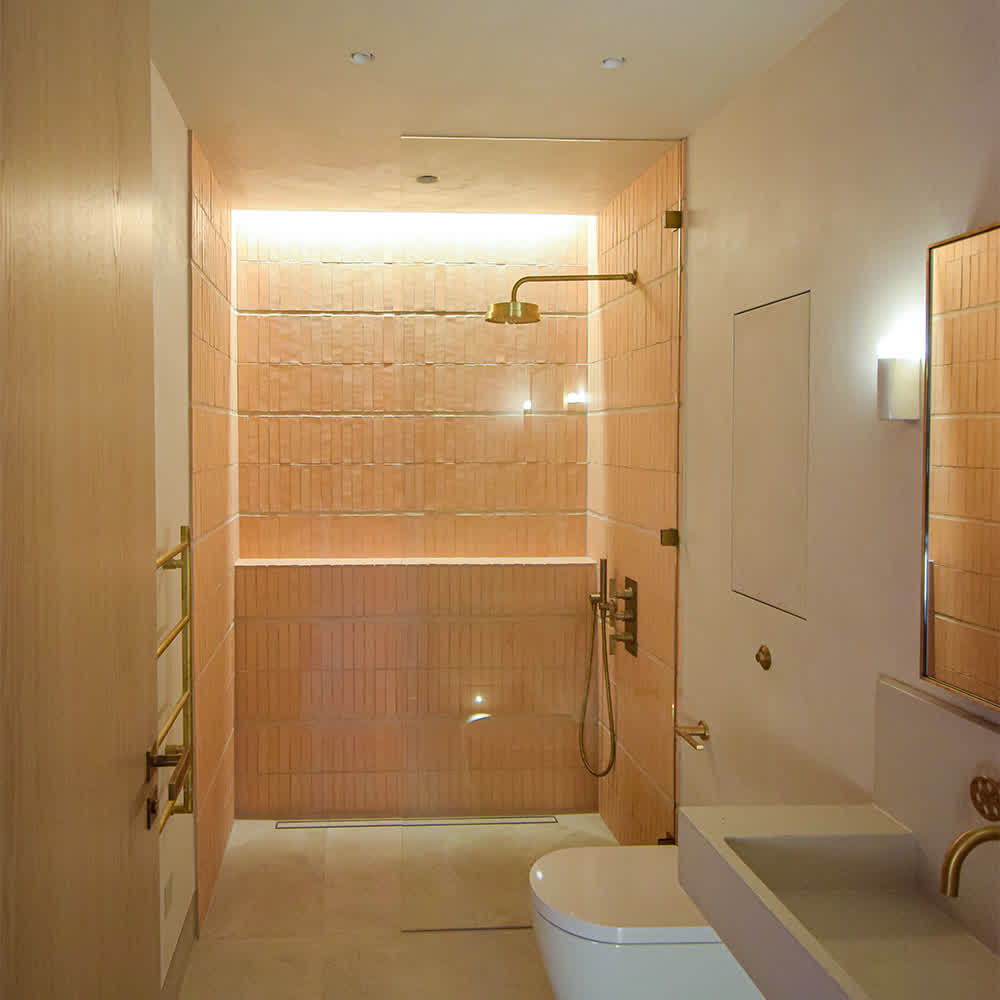 glass shower screen with brass clamps