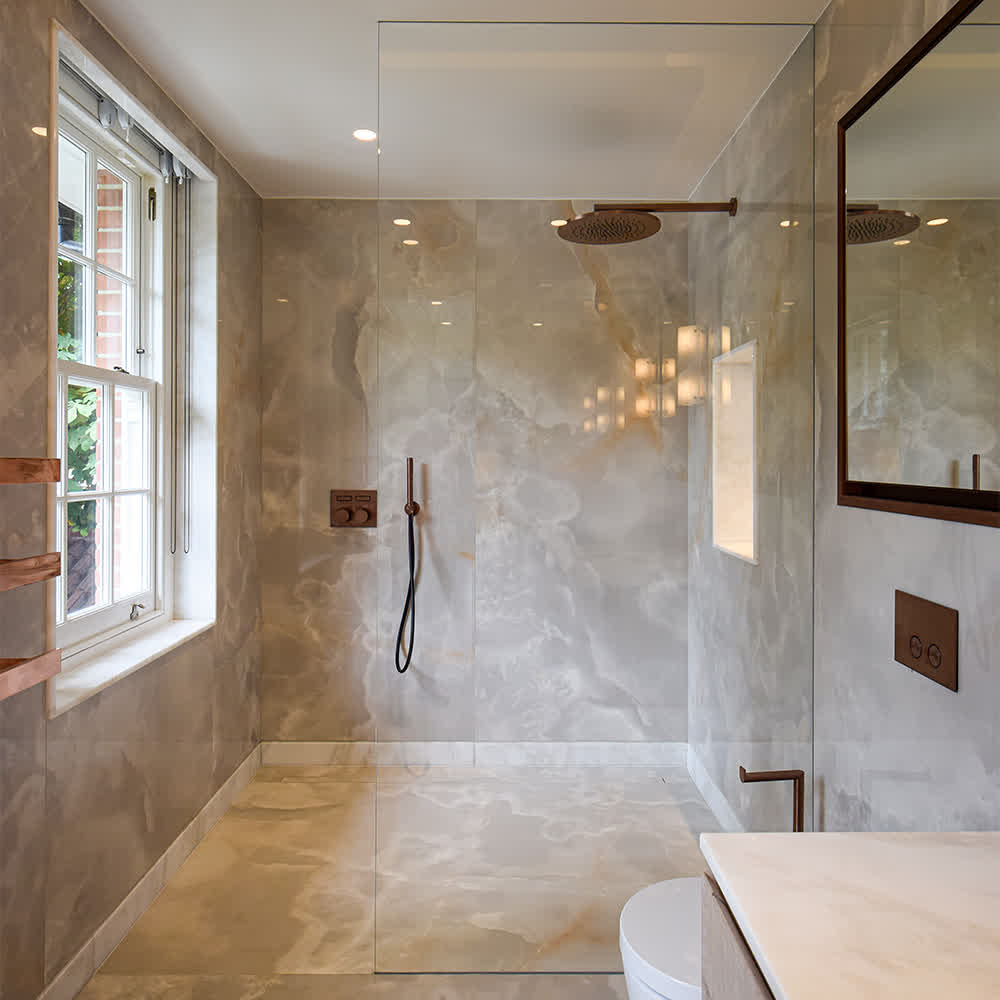 Walk-in shower with frameless glass shower screen and ceiling-mounted rainfall head