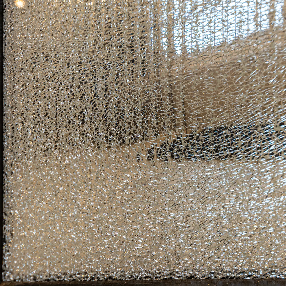 a panel of shattered laminated reeded glass in a frame