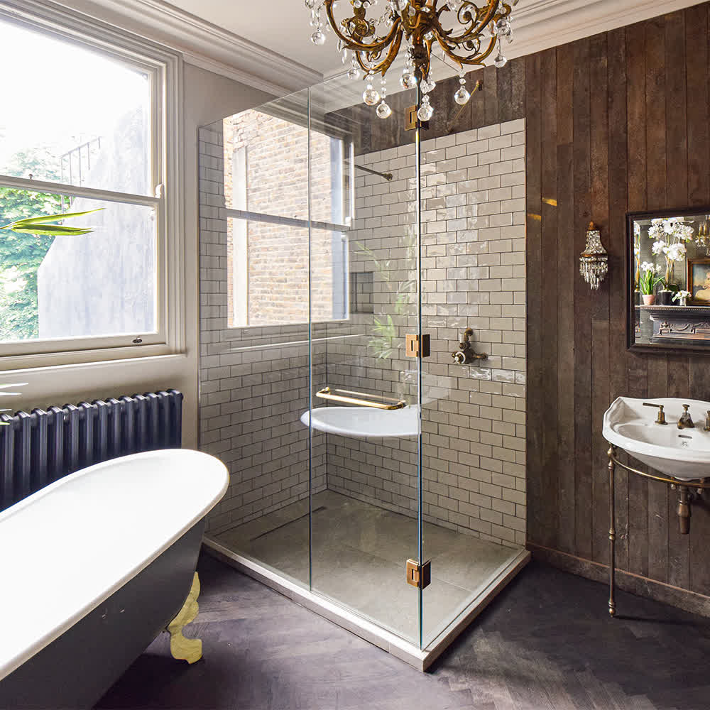 shower enclosure with antique brass hinges and towel rail